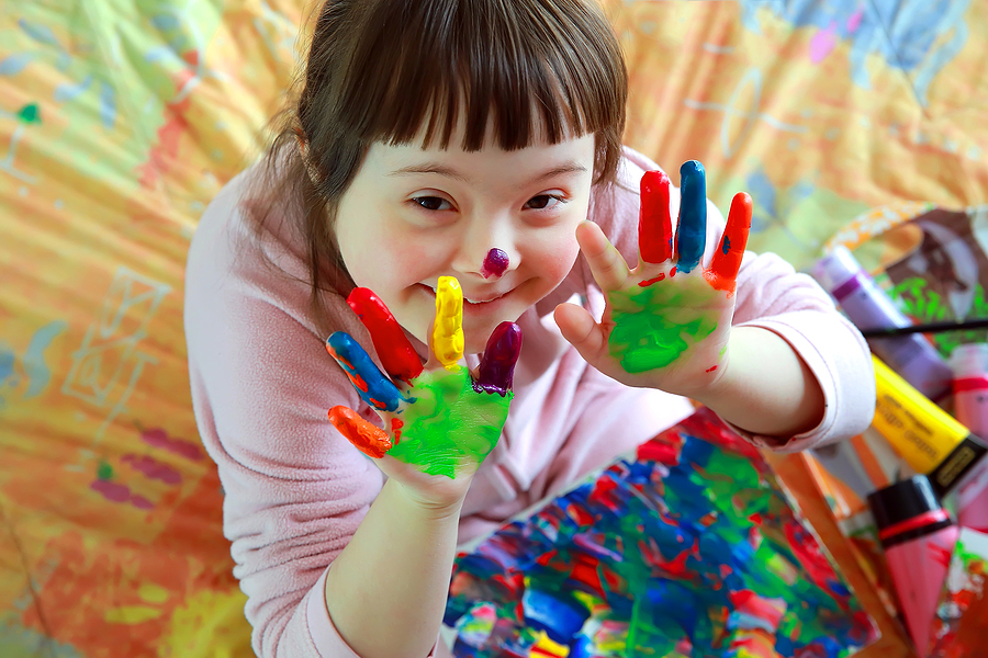 Cute little girl with painted hands .